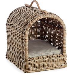 a wicker dog bed with a cushion