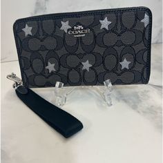 Signature Jacquard In Charcoal With Silver Stars And Refined Pebble Leather, 6 Card Slots, Id Window, Zip Coin Pocket, Inside Phone Pocket, Zip Closure, Removable Writ Strap 7.25" L X 4" H X .75" D Sequin Cards, Dream Bags, Wishlist 2024, Oxblood Leather, Credit Card Holder Wallet, Checkbook Wallet, Cute Wallets, Canvas Wallet, Billfold Wallet