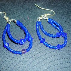 Deep navy blue seed bead double hoops with Austrian Crystal bi-cone deep blue 4mbeads on clear beading wire  with silver fish hook ear wires. These hoops can be made with smaller or larger hoops. With a single, double or triple hoop. A triple hoop is $1.00 additional for the set. The blue color is iridescent or AB blue and sparkles in any light. You can have a matching bracelet or necklace, the matching set is stunning. Blue Teardrop Hoop Earrings With Dangling Beads, Blue Small Hoop Beaded Earrings With Dangling Beads, Blue Wire Wrapped Beaded Earrings For Party, Blue Dangle Hoop Earrings With Tiny Beads, Blue Small Hoop Earrings With Tiny Beads, Blue Wire Wrapped Hoop Beaded Earrings, Double Hoop Earrings, Silver Fish, Personalized Gift Wrap