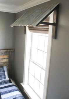 a bed sitting under a window in a bedroom