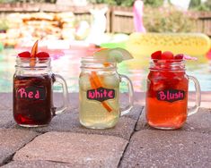 three mason jars filled with different types of drinks next to a swimming pool in the background