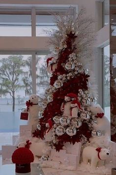 a white christmas tree with red and silver ornaments