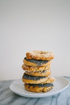 a stack of doughnuts sitting on top of a white plate