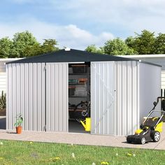 a small metal storage shed with a lawn mower