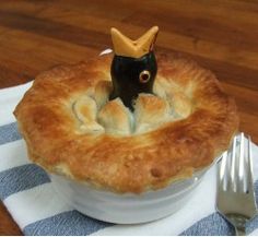 there is a small figurine in the middle of a pot pie with a crown on top