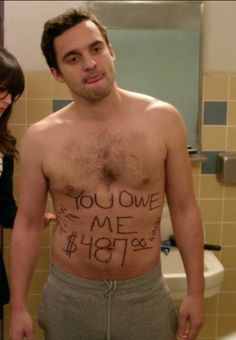 a shirtless man with writing on his stomach