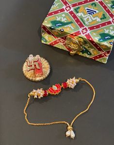 Enhance the sacredness of Raksha Bandhan with our Sacred Bhaiya Rakhi Combo. This set includes a beautiful Bhaiya Rakhi that symbolizes the cherished bond between siblings, along with a rice/sindoor accessory that adds a traditional touch to the celebration. Combo contains: 1 Box 1 Haldi/Rice/Sindoor Holder 1 Rakhi The color of the box will be random. Festive Sets With Latkans For Puja, Festive Adjustable Tikka For Puja, Traditional Tikka With Latkans As Gift, Traditional Red Tikka As Gift, Adjustable Tikka For Diwali Gift, White Temple Jewelry Sets As Gift, Diwali Tikka Gift, White Temple Jewelry Set For Gift, Red Tikka For Navratri