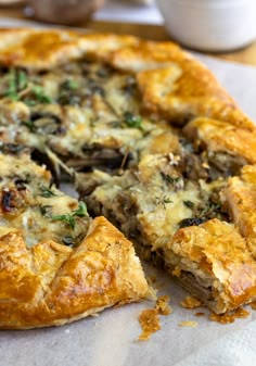 a close up of a pizza on a table with one slice missing from the pie