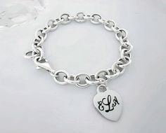 Our 925 Sterling Silver lightweight Toggle Bracelet is a timeless piece of jewelry that captures elegance and sentiment. The tag heart-shaped bracelet can be engraved with your choice of text, making it a deeply personal and cherished piece. Select lobster clasp, heart toggle or loop toggle. The bracelet features links in a classic cable design, each link measuring 10.5mm by 8.5mm.  IF YOU WANT THE ENGRAVED HEART TO BE LOCATED IN A SPECIFIC PLACE, PLEASE DROP ME A NOTE WITH YOUR INSTRUCTIONS. FEATURE: 925 Sterling Silver cable chain bracelet. Link Size: 10.5mm x 8.5mm Style: Toggle Bracelet Personalization: Engraved Heart Classic Cable Links: The cable-style links add a touch of traditional elegance to the bracelet, making it suitable for both everyday wear and special occasions. The heart Classic Sterling Silver Bracelet With Charms, Classic Sterling Silver Personalized Charm Bracelet, Classic Personalized Sterling Silver Charm Bracelet, Personalized Classic Sterling Silver Charm Bracelet, Classic Sterling Silver Charm Bracelet With Heart, Classic Gold Heart Bracelet, Classic White Gold Heart Bracelet As Gift, Classic Heart-shaped Bracelets With Sterling Silver Clasp, Classic Sterling Silver Bracelet For Valentine's Day Gift