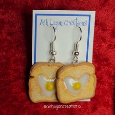 Egg in Toast Earrings Toast slices measure approximately between 1.5cm to 2.25cm Materials: ▫ Polymer Clay ▫ Hypoallergenic Hanging Earring Hook Each Toast is handmade by me, so you may receive a pair of earrings that are slightly different from the ones pictured in the listing. As they are all made by hand all are similar but no two pairs will ever be the same! I can also do custom orders. Please feel free to send me a message with any questions or ideas! Thanks for checking out my shop! Everyday Nickel-free Resin Jewelry, Resin Drop Earrings With Ear Wire, Novelty Jewelry Gift Set With Matching Earrings, Nickel-free Resin Jewelry For Crafting, Hypoallergenic Resin Jewelry For Everyday, Everyday Hypoallergenic Resin Jewelry, Novelty Hypoallergenic Drop Earrings, Cute Hypoallergenic Resin Jewelry, Resin Earrings For Gifts