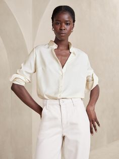 Relaunch to our classic silky shirt in new recycled polyester fabric, silky crepe. More of a cleaner matte finish making this piece more elevated and modern. Point collar. Long sleeves with button cuffs. Button front closure. Back yoke with center box pleat. Shirttail hem. Made exclusively for Banana Republic Factory. #890602 Silky Shirt Outfit, Banana Republic Outfits, Silky Shirt, Timeless Wardrobe Staples, Top Banana, White Button Down Shirt, Recycled Polyester Fabric, Banana Republic Women, Satin Shirt