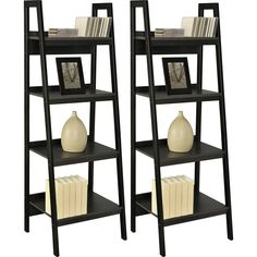 two black shelves with books and vases on them