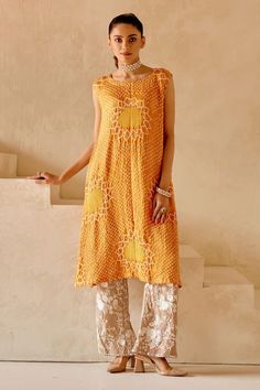 Orange shift dress kurta with sunflower patterns in crushed bandhani work and side button down panels. - Aza Fashions