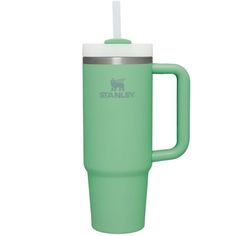 a green travel mug with a straw in the top and handle on it's side