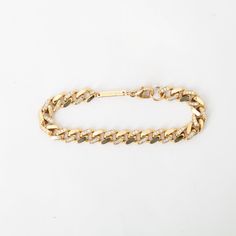 This one might ﻿actually﻿ be the baddest of them all. Thick gold links are accented with pavé diamonds for a heavy metal look that's effortlessly elegant. Wear it alone to elevate any look day or night, or stack it with your favorite bracelets for a stunning play of metals and textures. Made in the U.S.A. Measures 6.5" long and 7 mm wide. 14 karat yellow goldset with approximately 0.72ctw white diamonds. Curb Chain Bracelet, Band Necklace, Elegant Wear, Single Stone, Diamonds And Gold, Band Engagement Ring, Custom Engagement Ring, Curb Chain, Fine Jewellery