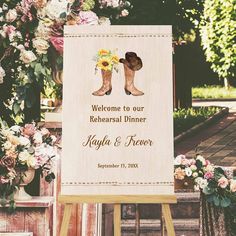 a welcome sign with boots and flowers on it