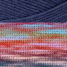 multicolored yarn is being used to create an abstract pattern on the surface in this image