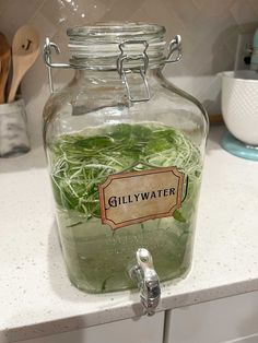 a glass jar filled with water sitting on top of a counter