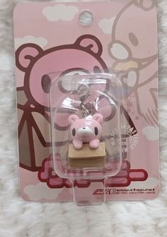 a key chain with a pink bear on it