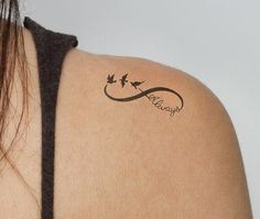 a woman's back with a tattoo on her left shoulder and the word love is written in cursive writing