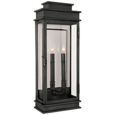 an outdoor wall light with two candles on it