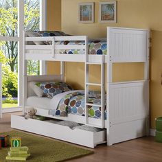 a white bunk bed sitting on top of a hard wood floor next to a window