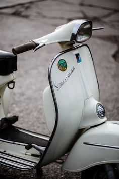 a white scooter is parked on the street