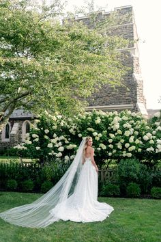 a woman in a wedding dress is standing outside