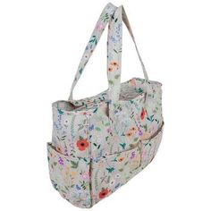 a white bag with flowers on the front and bottom, hanging from it's side