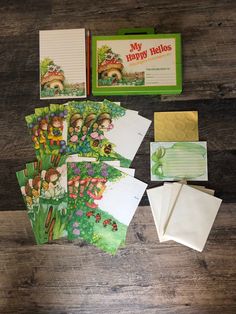 the contents of a children's book laid out on a wooden table with papers and envelopes