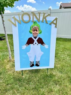 a sign that says monka on it in front of a yard with grass and trees