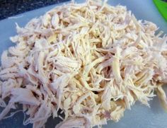 shredded chicken sitting on top of a cutting board