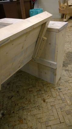 a wooden bench sitting on top of a brick floor