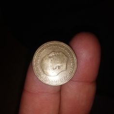 a person holding a coin in their hand