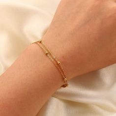 The Gemma Double Satellite Bracelet is a great layering piece, it is dainty but still makes a statement! With a youthful and contemporary feel, this adorable bracelet is a must-have for your stacking bracelet collection. Chain Length: 6 3/4" with a 1 1/4" extender 18K Gold Plated Stainless Steel Double Satellite Chain Water and Tarnish Resistant: Crafted to withstand everyday wear and tear Hypoallergenic: Made with high-quality materials and is safe for those with sensitive skin. Satellite Bracelet, Double Chain, Stone Gold, Chain Gold, Cute Bracelets, Bracelet Collection, Jewelry Cleaner, Organza Bags, Bracelet Stack