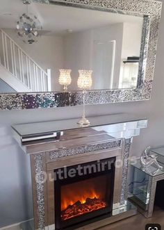 a fireplace with a mirror above it and a fire place in front of the fireplace