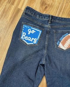 Looking for painted jeans? I am now doing customizable jeans!🩵🫶🏼🤪 #jeans #paintedjeans #art #paint #seniorjeans #smallbusiness Homecoming Jeans Painted, Painted Jeans School Spirit, Hoco Jeans Painted, Homecoming Painted Jeans, Spirit Jeans Ideas, Highschool Parking Spot Ideas