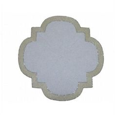 the back side of a white and beige flower shaped coaster with an intricate design on it