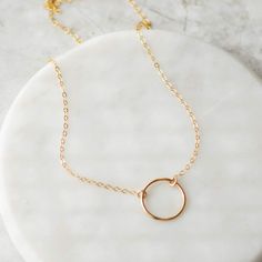 Beautiful 14k gold filled circle necklace that goes with everything. Perfect for everyday wear. Layer it with other gold necklaces or wear it alone. Details: Material: 14k gold filled Length: 16 inches Size: 13mm circle 14k Gold Filled Clavicle Chain With Round Pendant, Everyday Full Circle 14k Gold Jewelry, Everyday 14k Gold Full Circle Jewelry, Everyday Circular Yellow Gold Necklace, Everyday Yellow Gold Circular Necklace, Everyday Clavicle Chain Jewelry, Everyday 14k Gold Open Circle Jewelry, Minimalist Yellow Gold Open Circle Jewelry, Minimalist Yellow Gold Open Circle Necklace