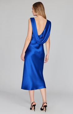 Our signature bias cut silhouette, updated with a gracefully draped front and low back detail. Cut in a flattering midi length with a clean baby hem finish. This dress is unlined and needs no closures thanks to the nature of bias cut fabric. Elegant Blue Cowl Neck Dress, Fitted Bias Cut Midi Dress With Cowl Neck, Blue Cowl Neck Party Dress, Chic Blue Cowl Neck Dress, Blue Fitted Cowl Neck Dress, Evening Draped Midi Dress With Ruched Back, Draped Midi Dress With Ruched Back For Evening, Pre-draped Bias Cut Dress, Blue Midi Length Dress With Bias Cut