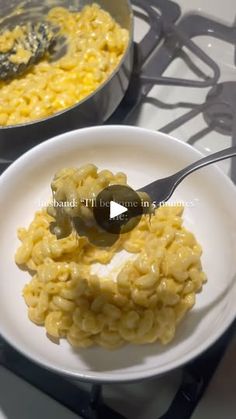 a white plate topped with macaroni and cheese next to a pot of food