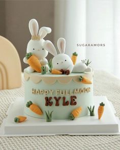 there is a cake decorated with rabbits and carrots