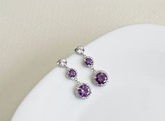 Purple Amethyst Earrings, Cubic Zirconia Amethyst Earrings, Bridesmaids Earrings, Purple and White  Round Drop Cubic Zirconia Long Dangle EarringsThe earrings are made with high quality hypoallergenic rhodium plated cubic zirconia ear posts (925 sterling silver posts) and 9mm and 14mm rhodium plated white and purple amethyst cubic zirconia round drops.The earrings measure 1 1/2 inch (38mm).*****All metal Components are Hypoallergenic, High quality plated, Anti tarnish and have Long lasting color Purple Cubic Zirconia Earrings For Wedding, Purple Prong Set Earrings For Wedding, Purple Wedding Earrings With Prong Setting, Purple Prong Set Wedding Earrings, Purple Amethyst Earrings, Bridesmaids Earrings, Earrings Purple, Long Dangle Earrings, Cubic Zirconia Earrings