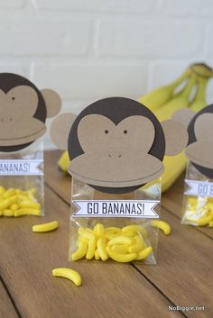 there are bananas and some monkeys on the table with tags in front of them that say go bananas