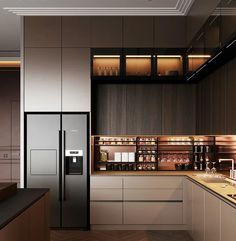 a modern kitchen with stainless steel appliances and wood flooring, along with dark colored cabinets