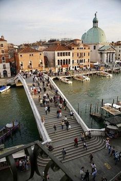 many people are walking on the bridge over water