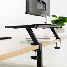 a computer monitor sitting on top of a wooden desk