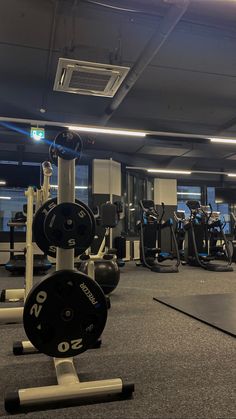 an empty gym with rows of exercise equipment