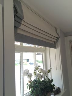 a vase with white flowers sitting on top of a window sill