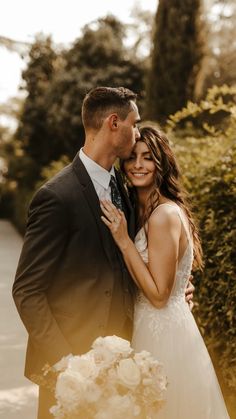 a bride and groom standing next to each other